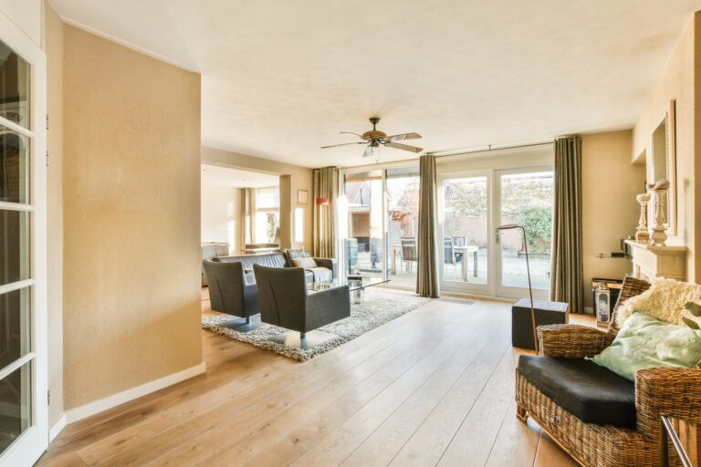 a living room with furniture and a ceiling fan