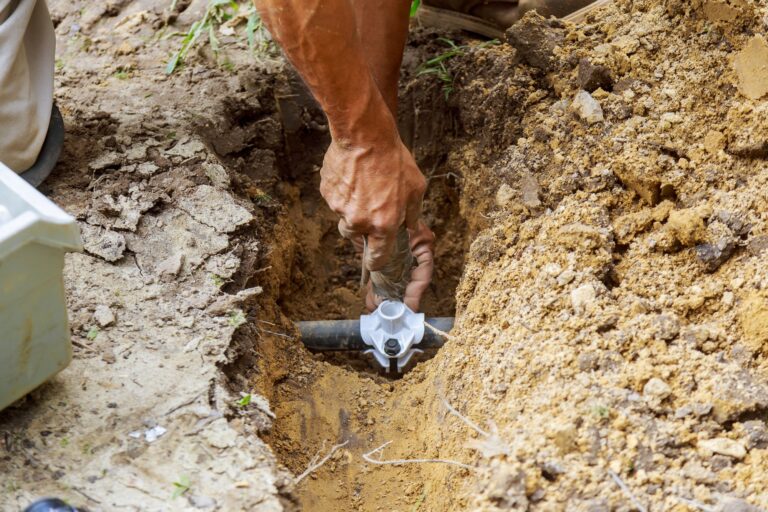 farmer installing irrigation system materials for completing